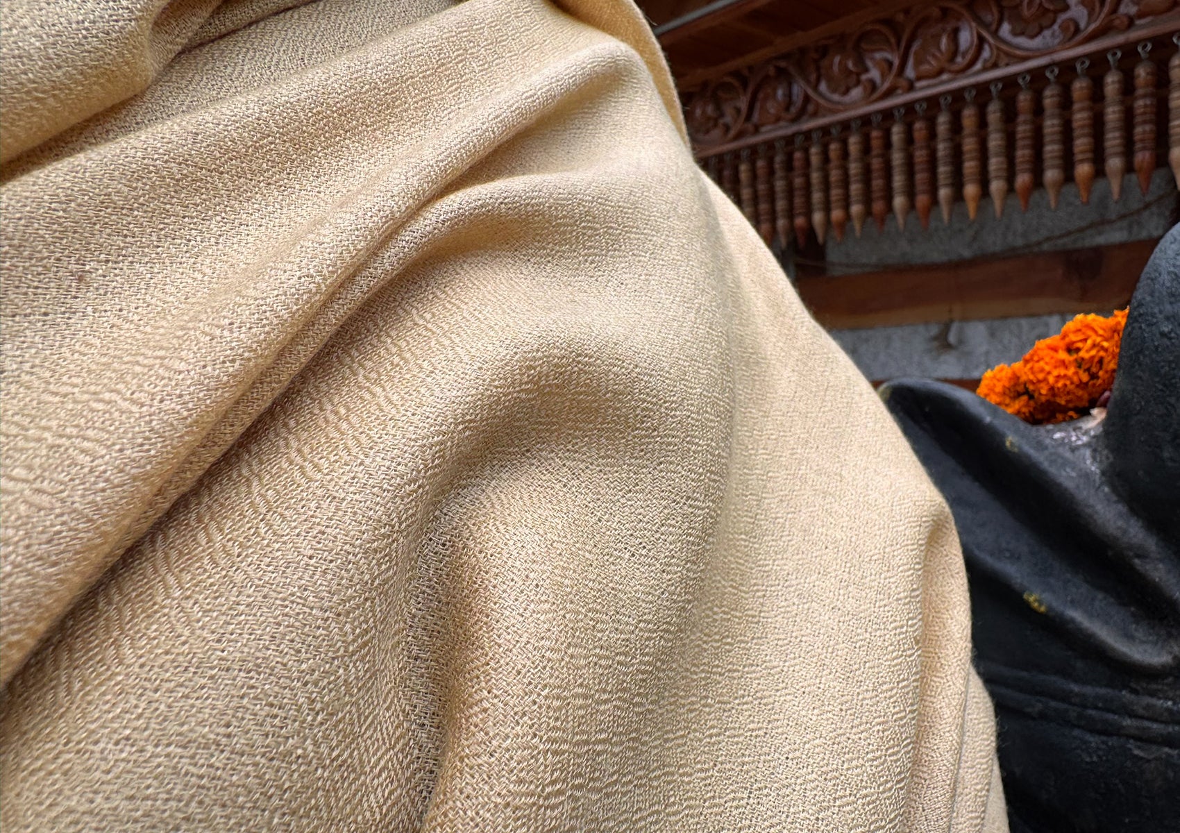 Close-up of beige meditation shawl worn during seated posture – soft and enveloping