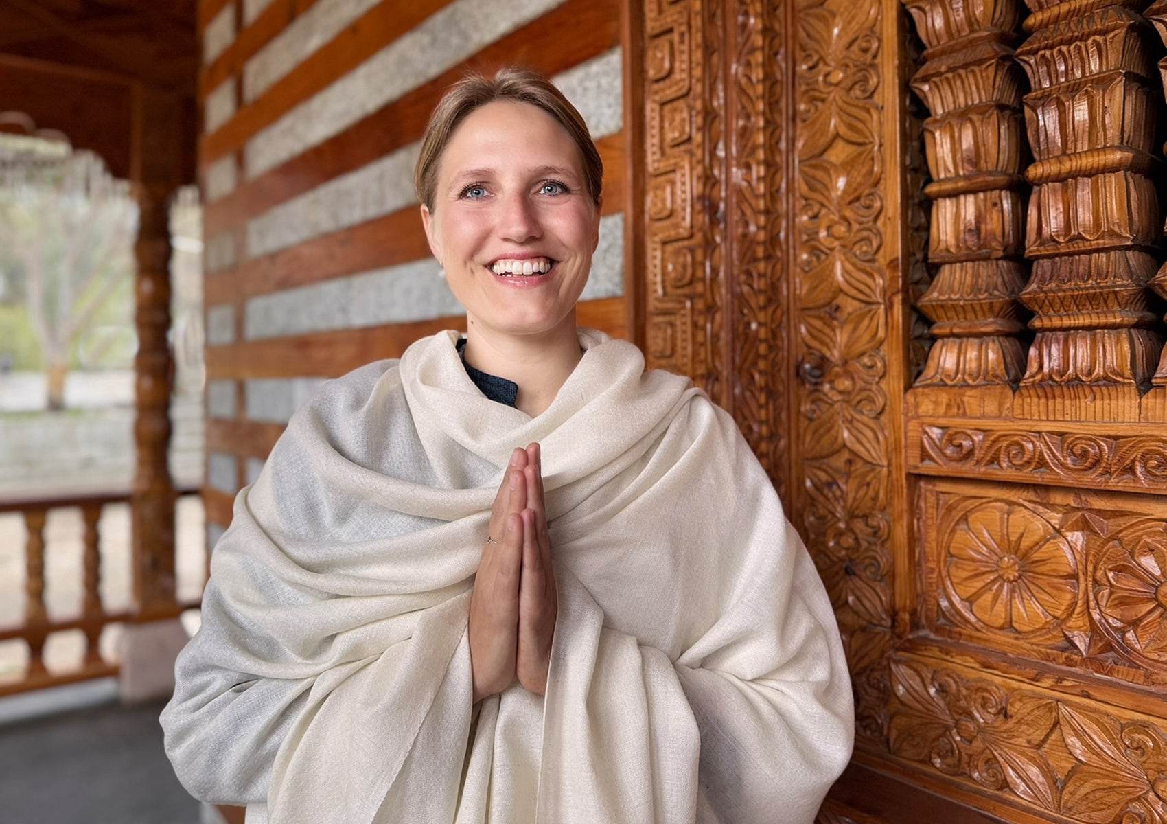 Side view showing the soft, enveloping drape of the Bodhi cream pashmina shawl