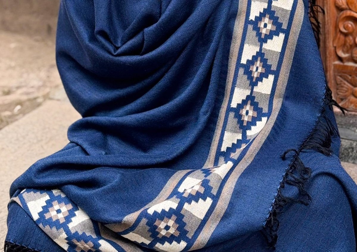 Detail of the border pattern of the Mahadev Shawl, handwoven in fine wool in blue and beige Himalayan tones.