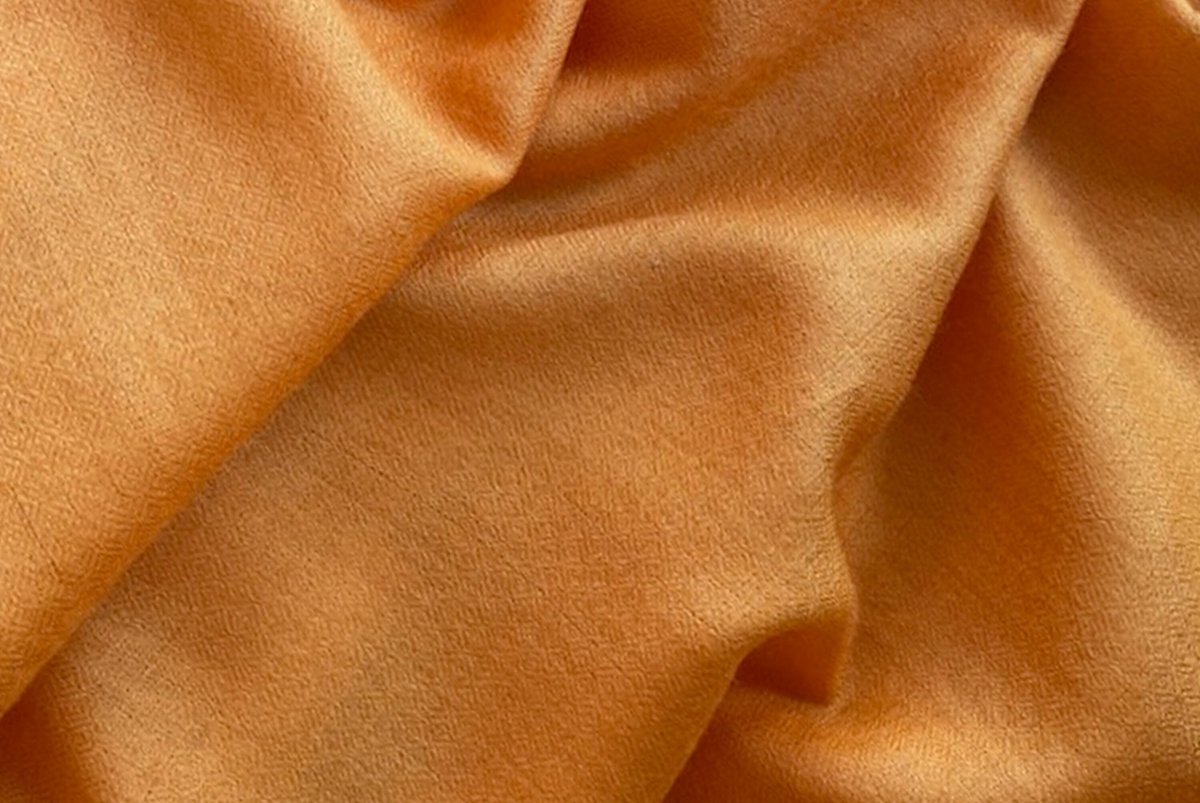 Himalayan orange fabric showing intricate details, suitable for meditation or as a cozy wrap.