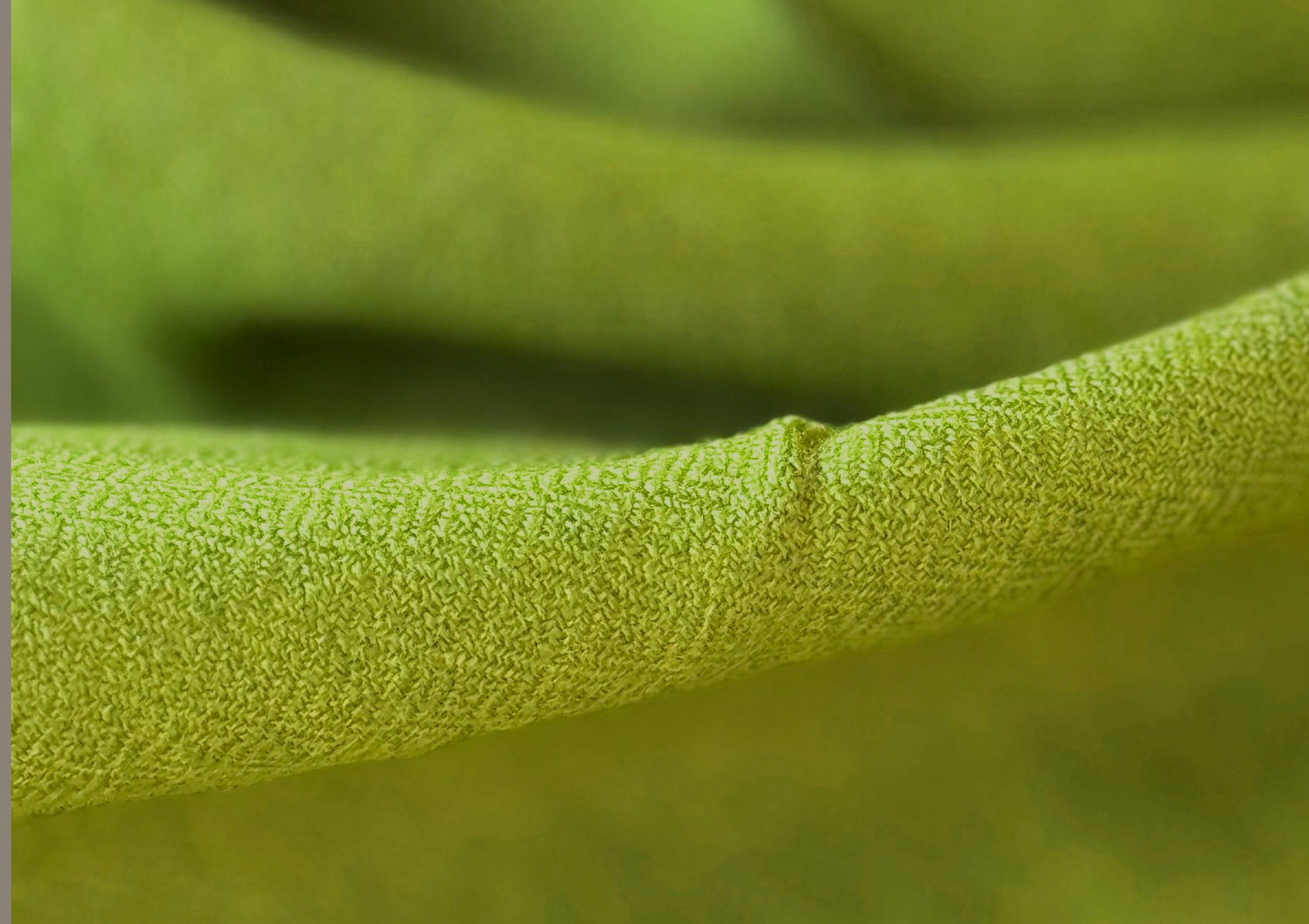 Extreme close-up of Lama Green meditation shawl showing detailed weave texture and soft merino fibers.
