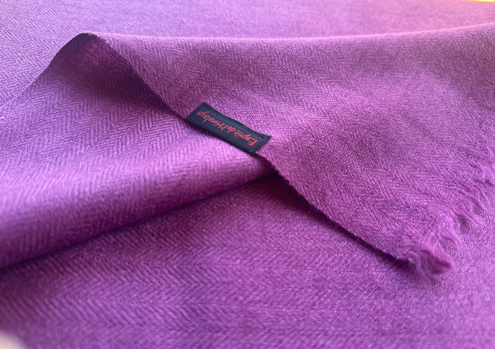 Folded Tibetan meditation blanket in LAMA light purple shade.