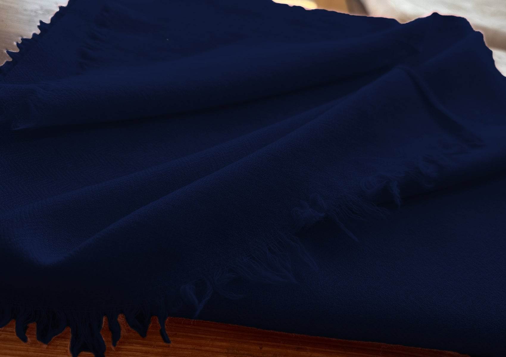 Close-up of the Lama navy blue large meditation blanket in soft handwoven wool.