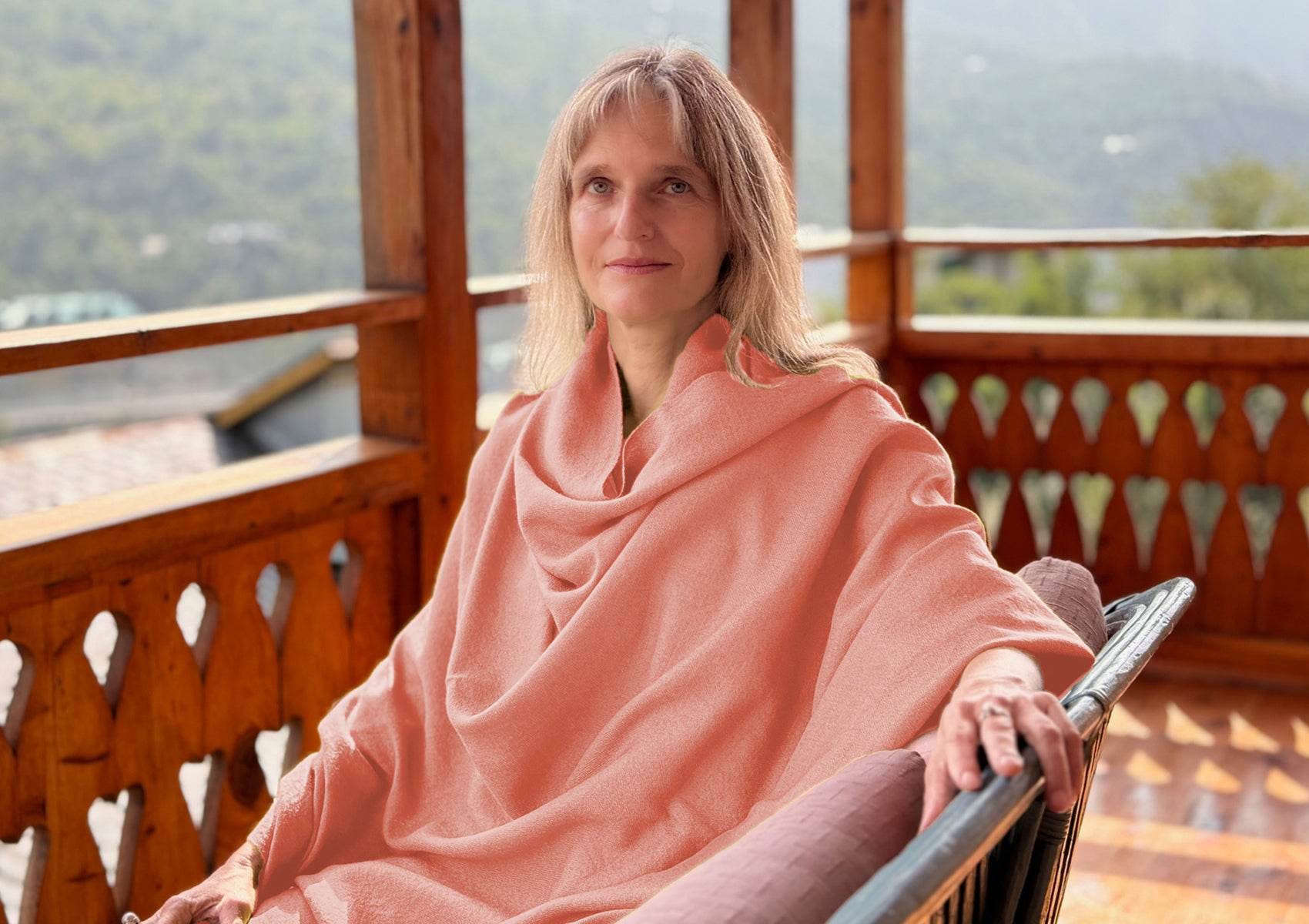 Handwoven peach merino wool shawl draped gracefully for Buddhist meditation practice.