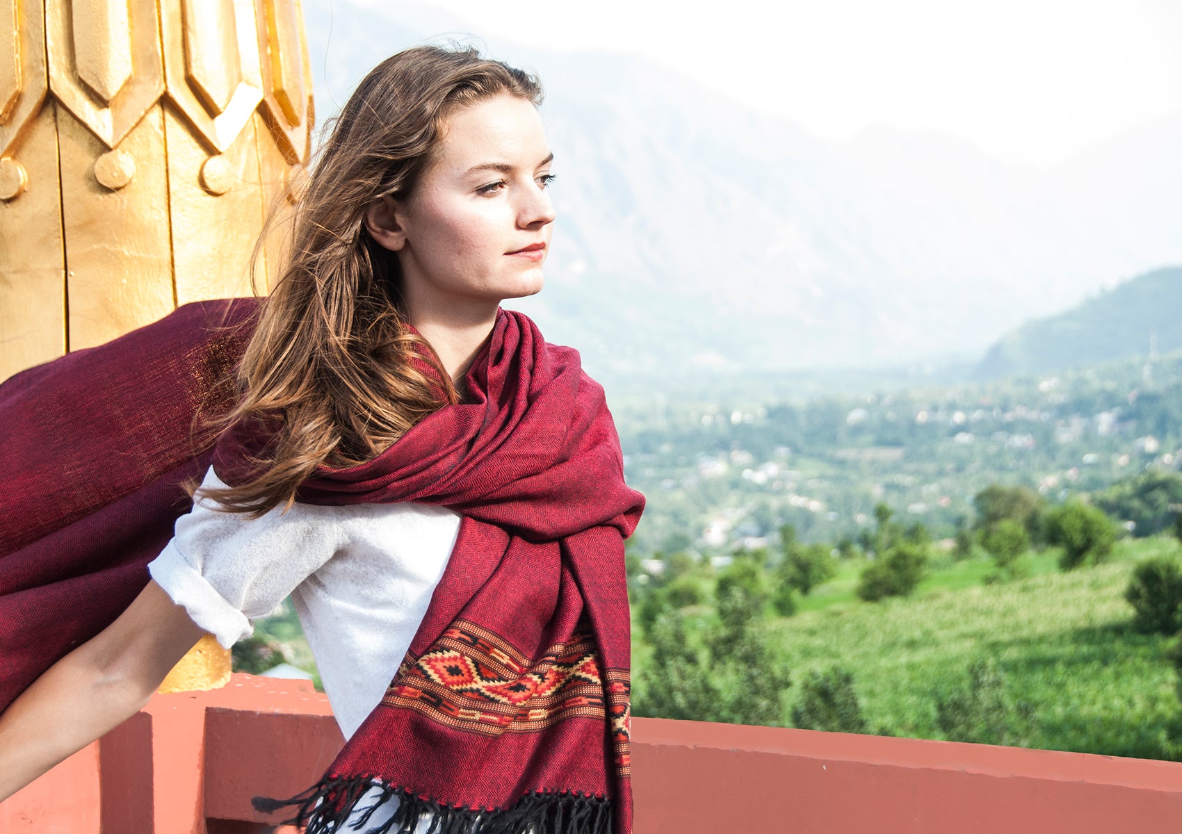 Detailed view of DEVA burgundy merino wool meditation shawl showing traditional woven ethnic border