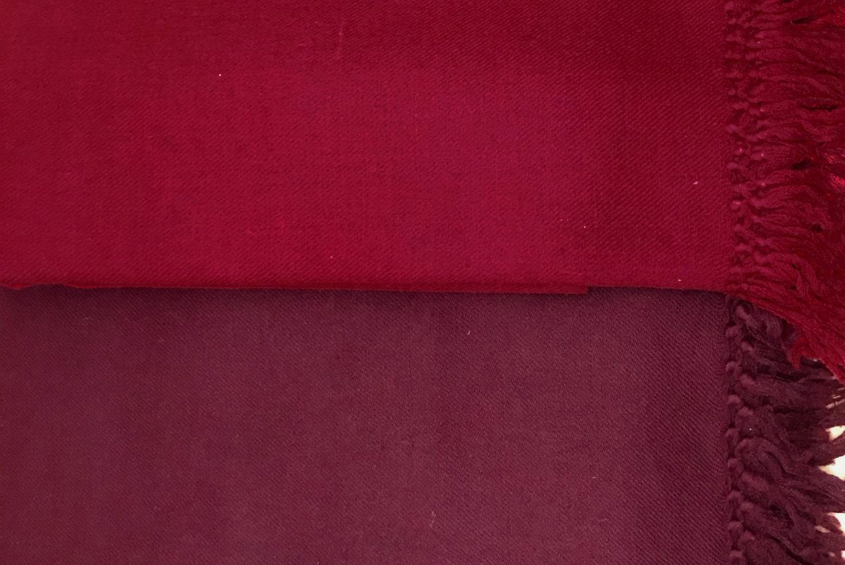 Burgundy meditation shawl draped over a surface showcasing its fine texture and deep color, ideal for Buddhist meditation practices.