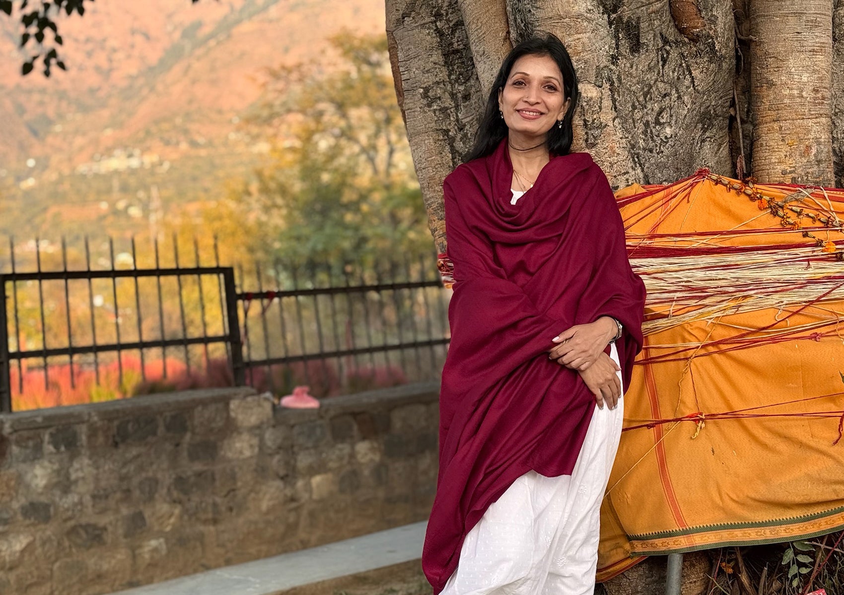 Detailed texture of a rich burgundy Himalayan pashmina shawl with luminous folds and velvety softness.