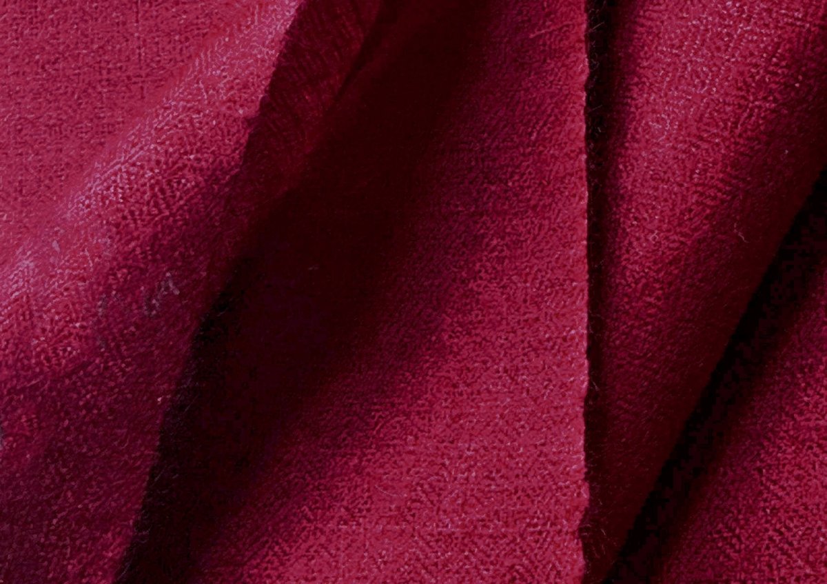 Close-up of a deep burgundy handwoven pashmina shawl showing fluid drape, softness, and refined texture.
