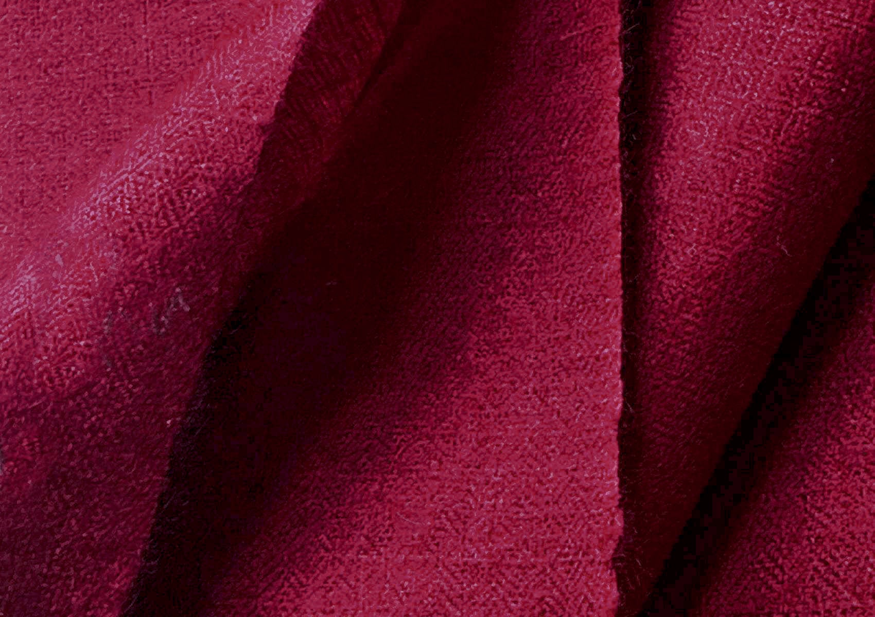 Close-up of a deep burgundy handwoven pashmina shawl showing fluid drape, softness, and refined texture.