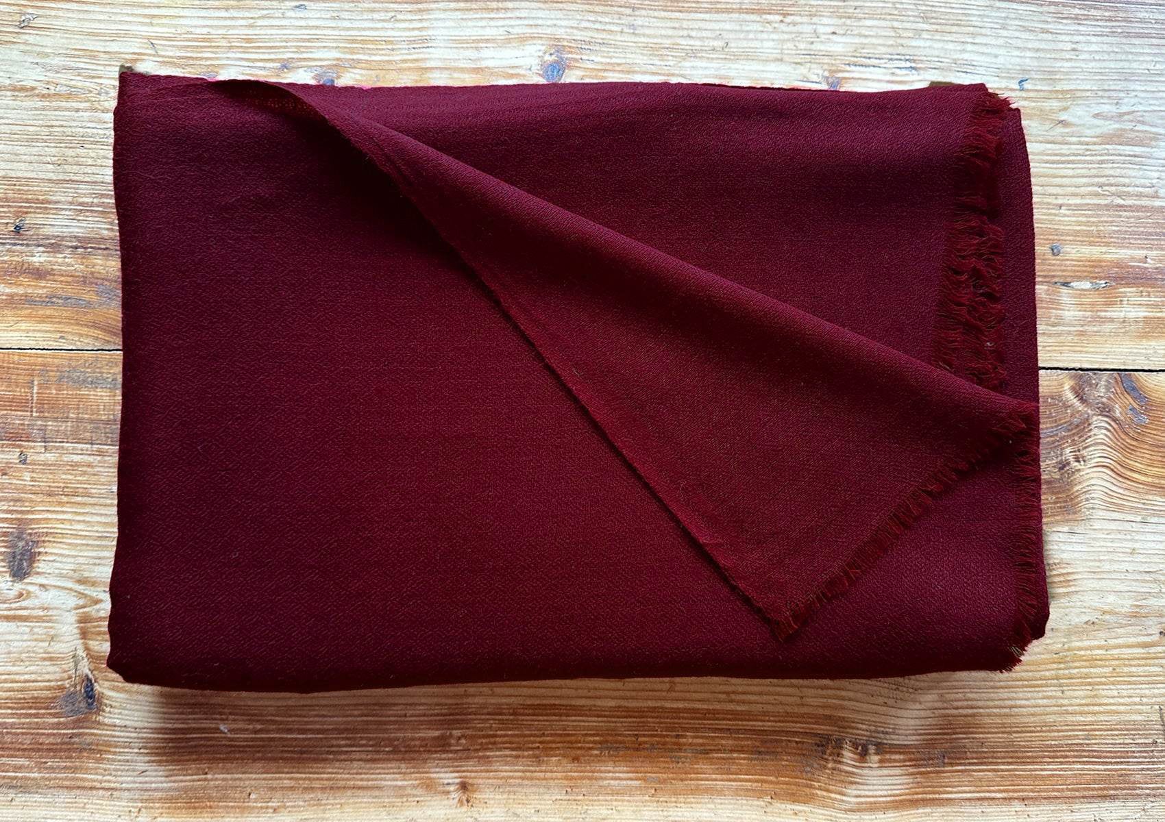 Elegant burgundy pashmina meditation shawl in soft Himalayan evening light, handwoven in Kashmir from fine Ladakhi pashmina.