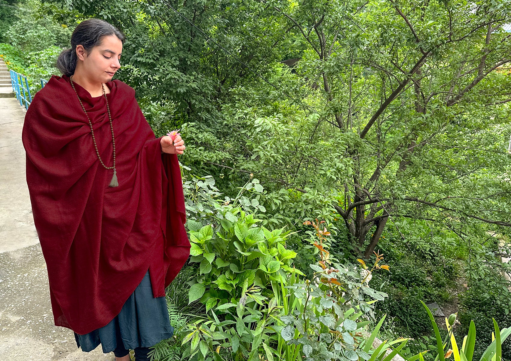 Close-up of the Shunyata shawl in burgundy showing its fine diamond weave