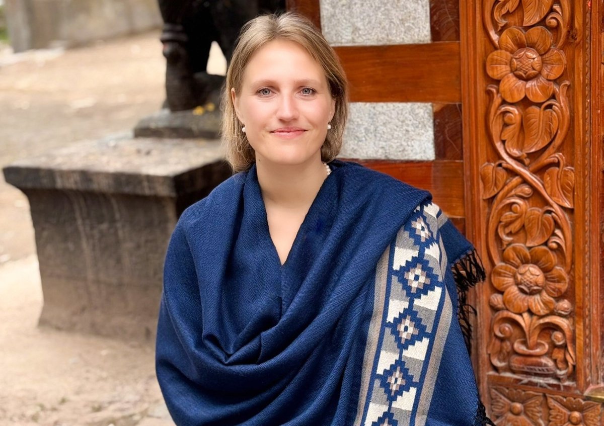 Close view of the Mahadev Shawl, a large handwoven Himalayan shawl in deep blue with a traditional patterned border.
