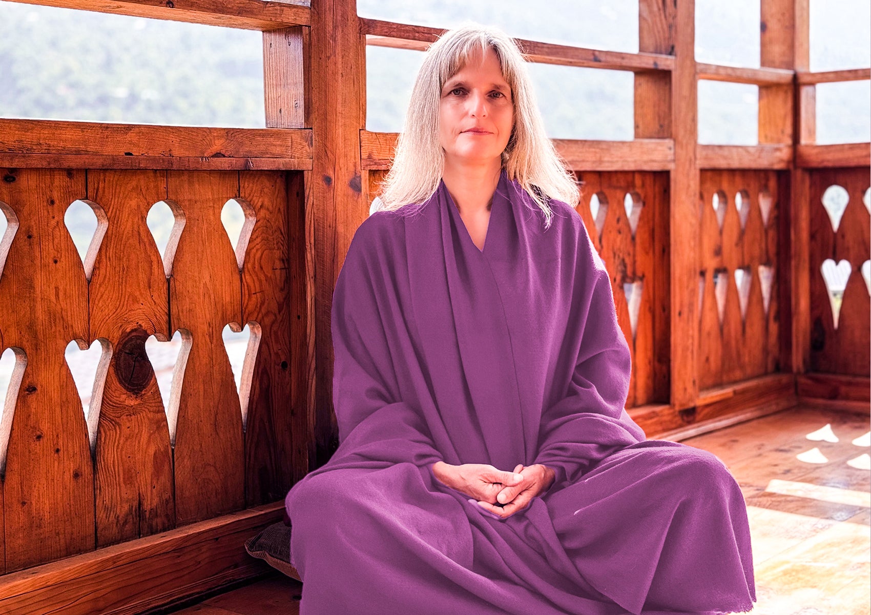 Woman seated in meditation wrapped in LAMA light purple Buddhist shawl.