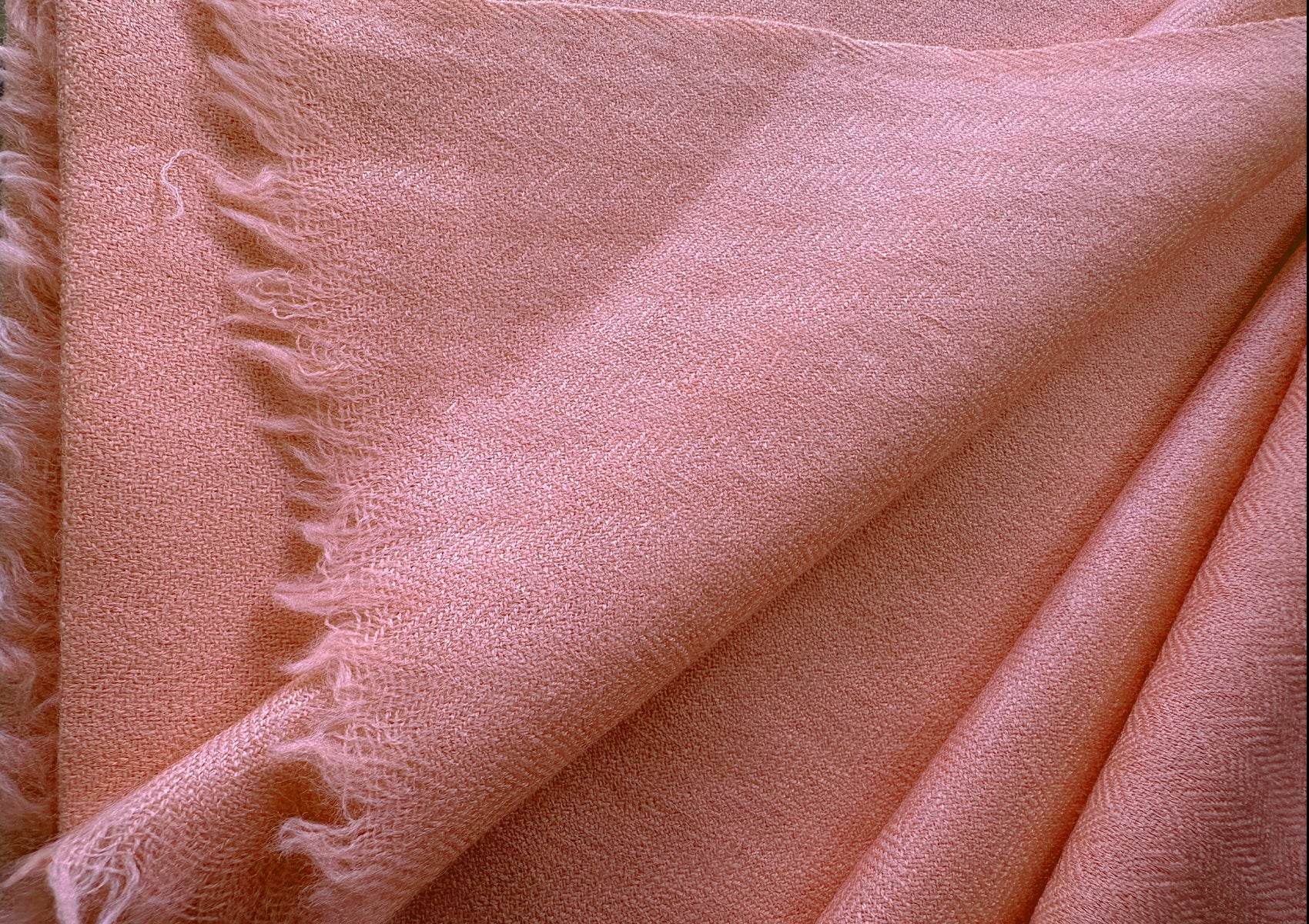 Detailed view of peach LAMA yoga shawl showing weave pattern and soft fabric folds.