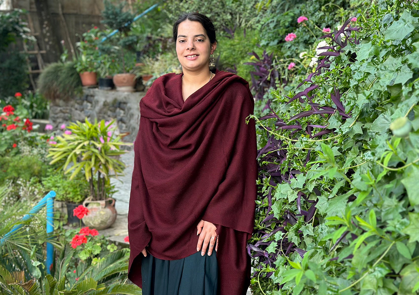 Outdoor scene with a burgundy Tibetan shawl, highlighting its use in various spiritual practices.